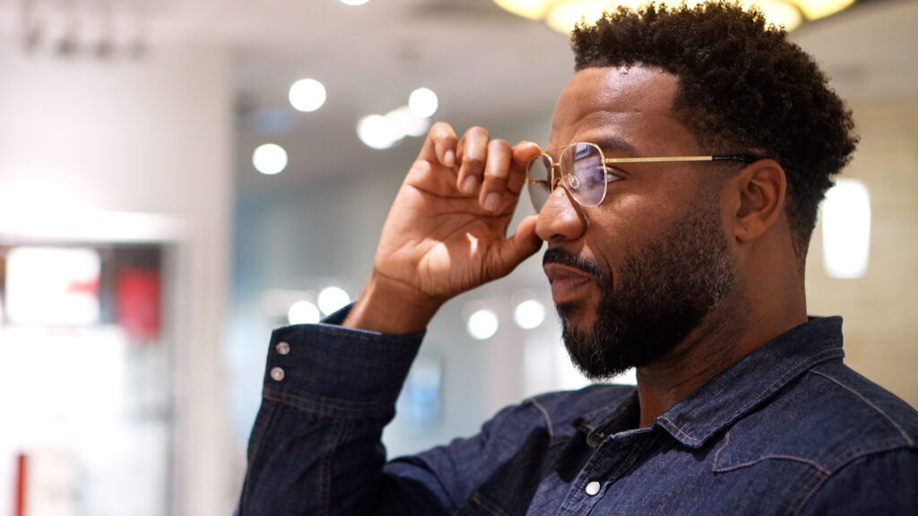 Man trying on glasses