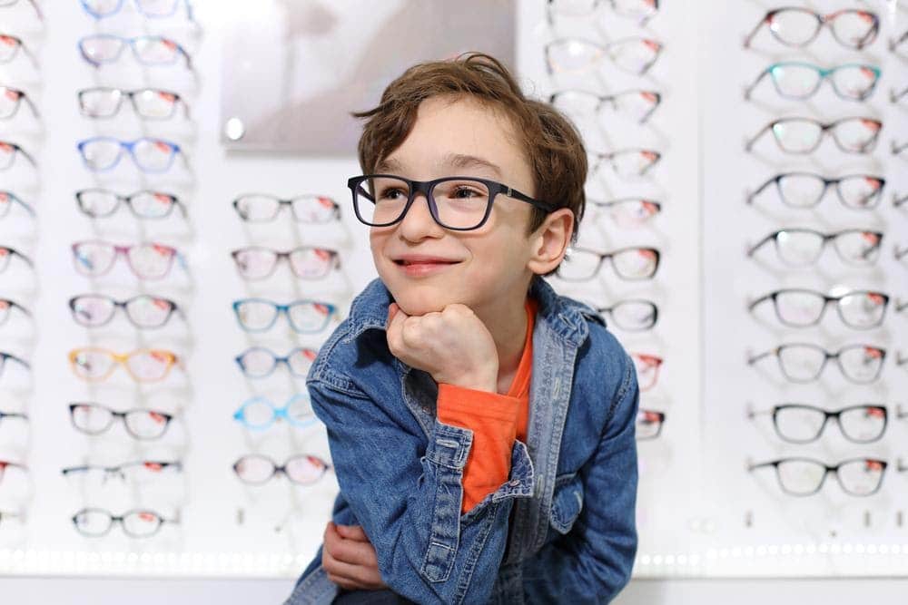 Little boy wearing spectacles in an optical shop
